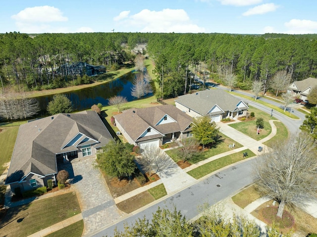 birds eye view of property featuring a view of trees and a water view