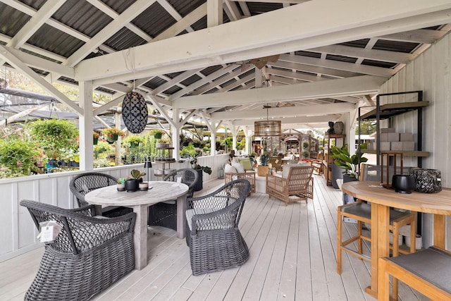 wooden terrace with a gazebo and outdoor dining area