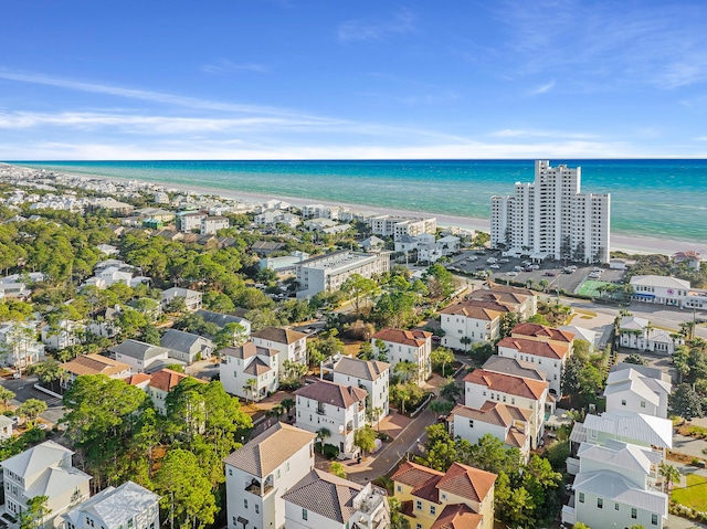 birds eye view of property with a water view and a view of the beach