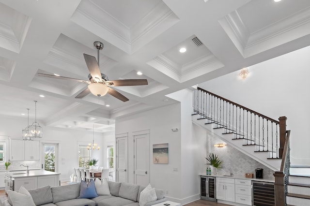 living room featuring visible vents, beverage cooler, and stairway