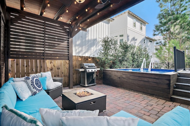 view of patio / terrace featuring an outdoor living space with a fire pit, fence, and grilling area