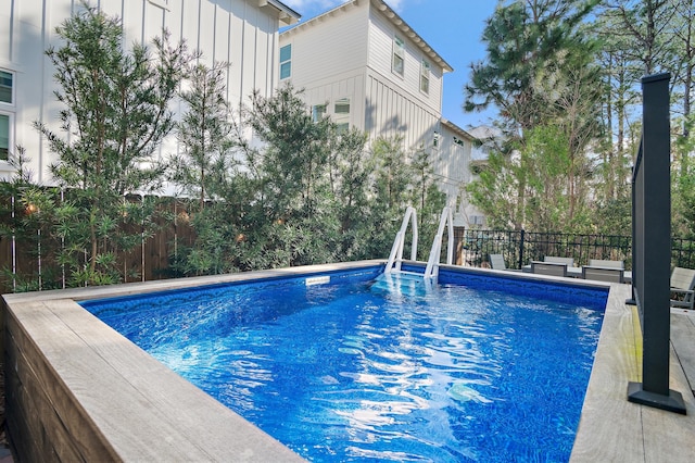 view of swimming pool with fence and a fenced in pool