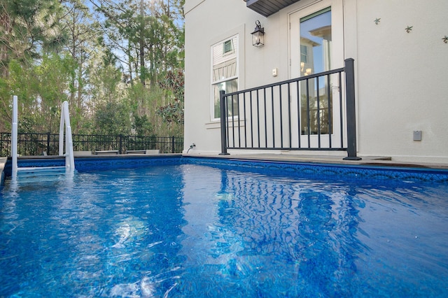 view of swimming pool featuring a fenced in pool and fence