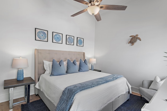 bedroom with ceiling fan, baseboards, and wood finished floors