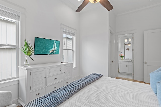 bedroom with connected bathroom, a ceiling fan, and crown molding