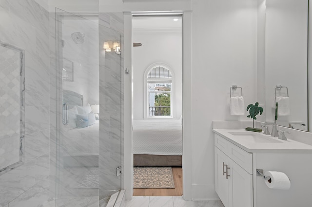 ensuite bathroom featuring vanity, ensuite bathroom, marble finish floor, and a marble finish shower