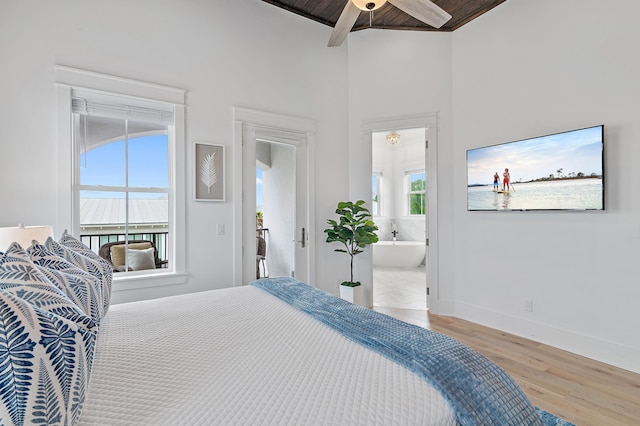 bedroom with wood finished floors, baseboards, ensuite bath, ceiling fan, and wooden ceiling