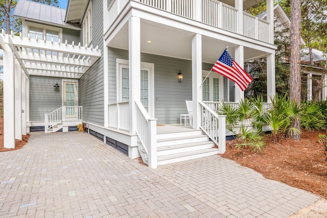 44 Thicket Cir, Santa Rosa Beach, FL 32459 - entrance to property with covered porch, metal roof, a balcony, and a pergola