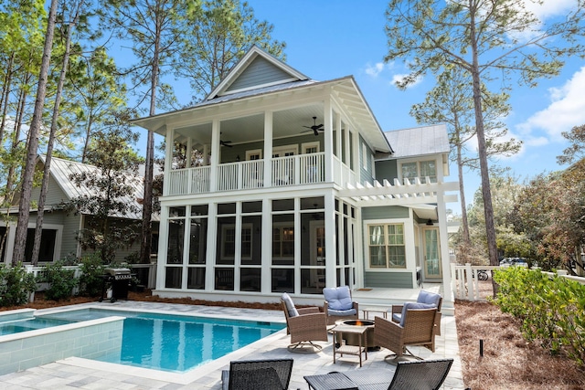 44 Thicket Cir, Santa Rosa Beach, FL 32459 - back of property featuring a balcony, ceiling fan, a sunroom, a patio area, and an outdoor living space with a fire pit