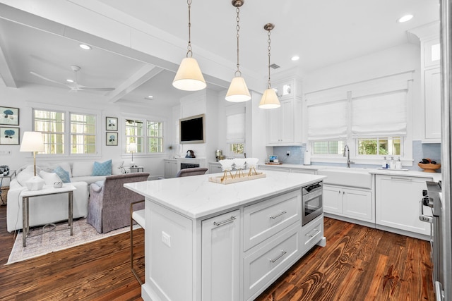44 Thicket Cir, Santa Rosa Beach, FL 32459 - kitchen with a sink, dark wood finished floors, open floor plan, white cabinetry, and a kitchen island