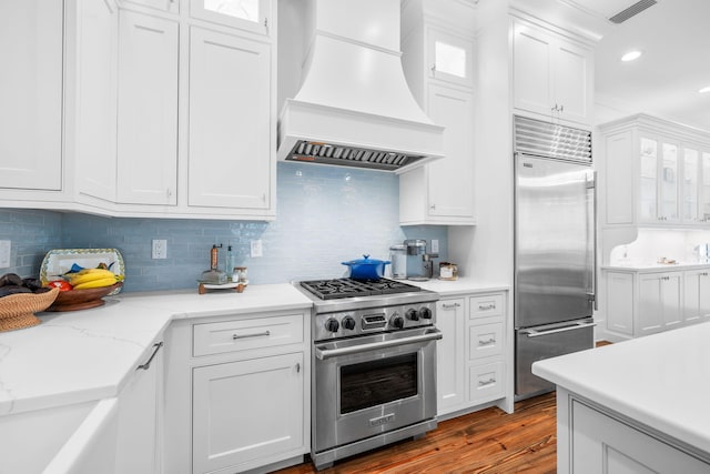 44 Thicket Cir, Santa Rosa Beach, FL 32459 - kitchen with premium appliances, premium range hood, white cabinets, backsplash, and recessed lighting