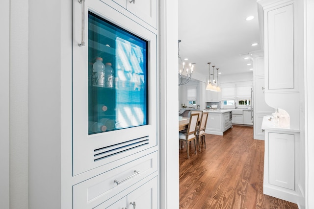 44 Thicket Cir, Santa Rosa Beach, FL 32459 - kitchen with wood finished floors, white cabinetry, light countertops, hanging light fixtures, and a chandelier