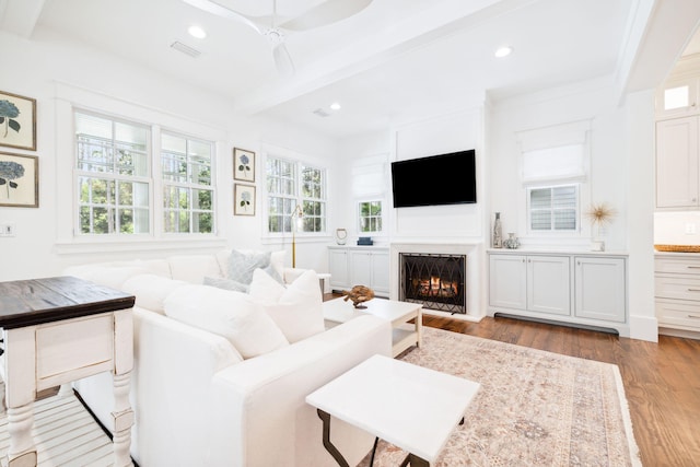 44 Thicket Cir, Santa Rosa Beach, FL 32459 - living room featuring plenty of natural light, beamed ceiling, wood finished floors, a warm lit fireplace, and recessed lighting