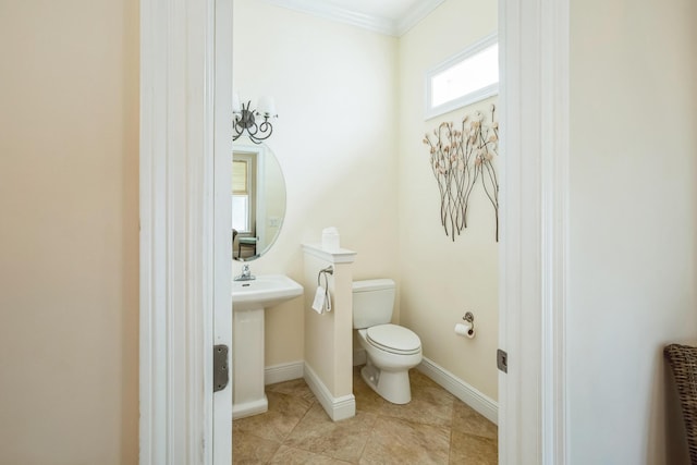 bathroom featuring crown molding, tile patterned flooring, toilet, and baseboards