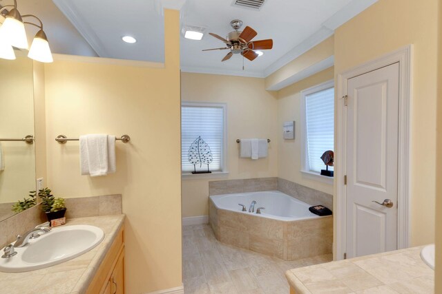 full bathroom featuring visible vents, a ceiling fan, a garden tub, crown molding, and vanity