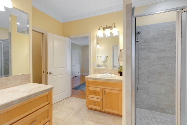 full bathroom featuring ornamental molding, a stall shower, and vanity