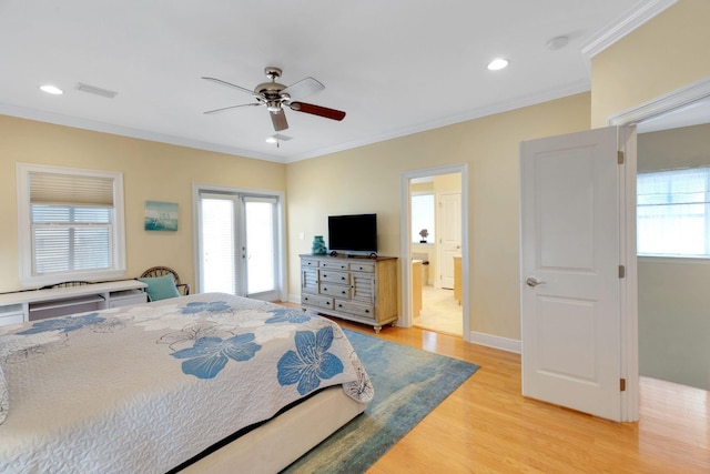 bedroom with light wood-style floors, visible vents, and crown molding