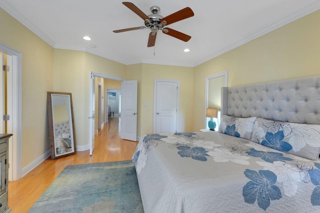 bedroom featuring ornamental molding, recessed lighting, light wood-style flooring, and baseboards