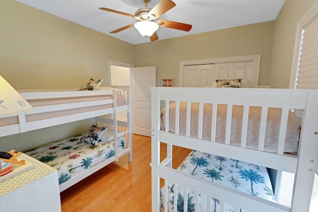 bedroom with light wood-style flooring and a ceiling fan