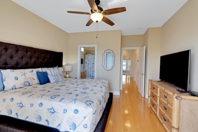 bedroom with light wood-style flooring, baseboards, ceiling fan, and ensuite bathroom