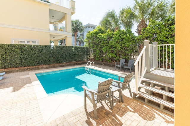 view of swimming pool with a fenced in pool and a patio