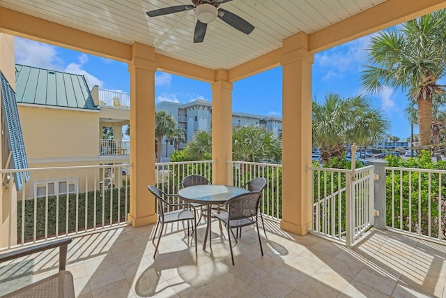 balcony with outdoor dining area and a ceiling fan