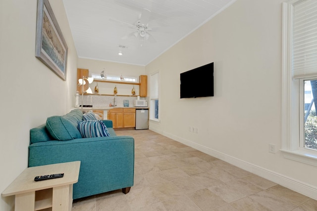 living room featuring visible vents, ceiling fan, and baseboards