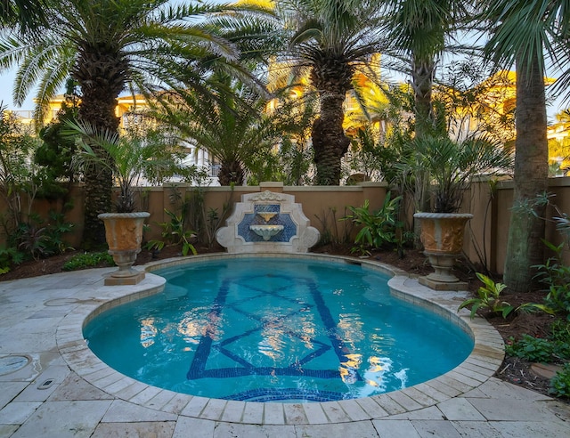 view of swimming pool with a fenced backyard