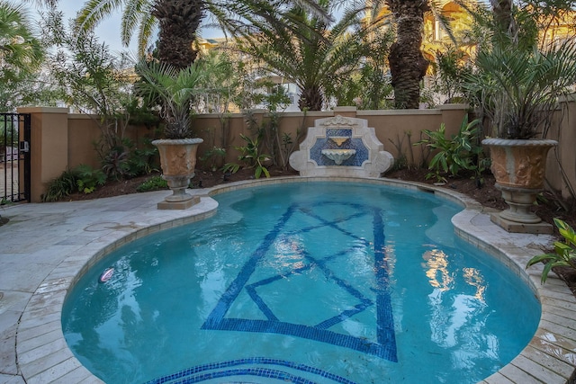 view of pool with a fenced backyard