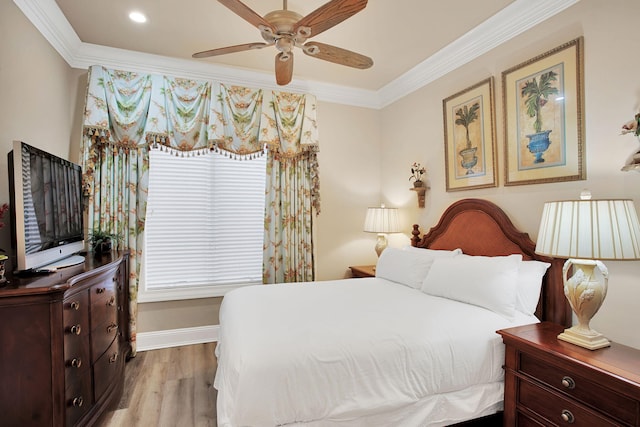 bedroom featuring ceiling fan, crown molding, baseboards, and wood finished floors