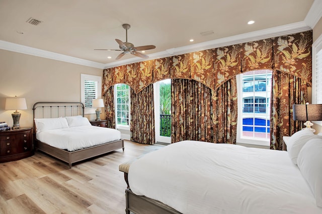 bedroom with wallpapered walls, crown molding, and light wood-style floors