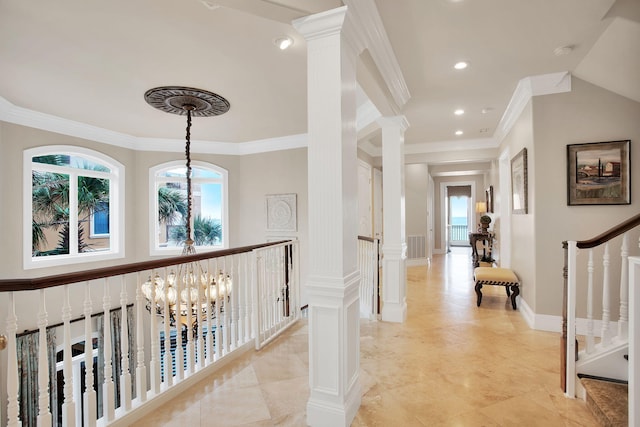 hallway featuring crown molding, a decorative wall, and a wainscoted wall