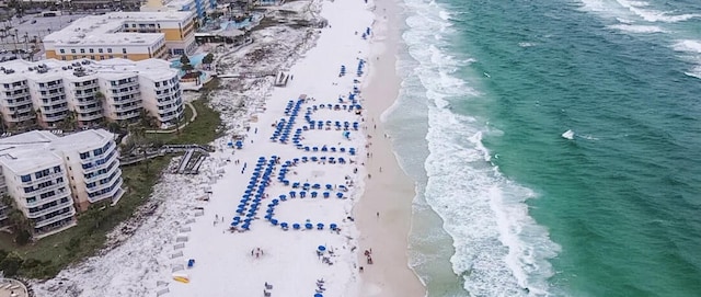 birds eye view of property featuring a water view and a beach view