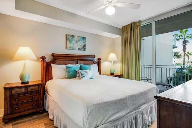 bedroom featuring ceiling fan, access to outside, floor to ceiling windows, and light wood-style flooring