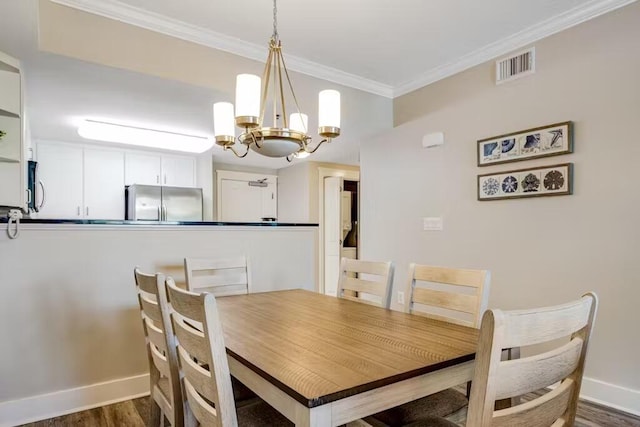 dining space featuring baseboards, visible vents, ornamental molding, dark wood-type flooring, and a chandelier