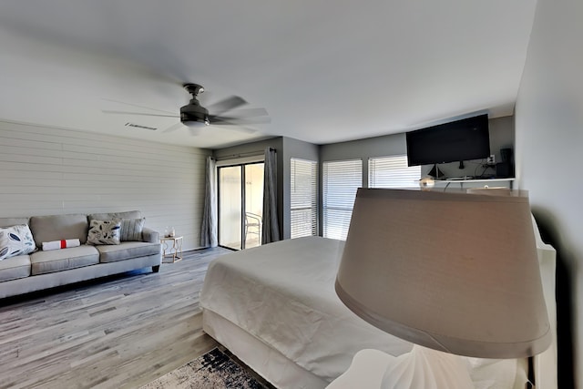 bedroom with visible vents, ceiling fan, and wood finished floors