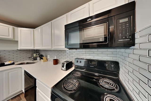 kitchen with white cabinetry, a sink, backsplash, and black appliances