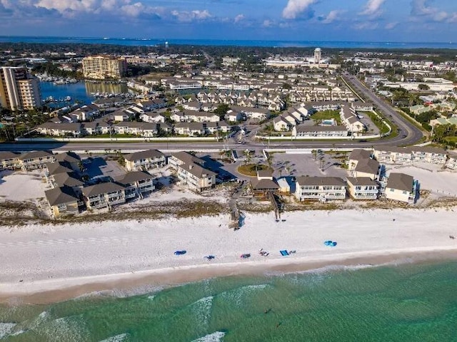 drone / aerial view featuring a water view and a view of the beach