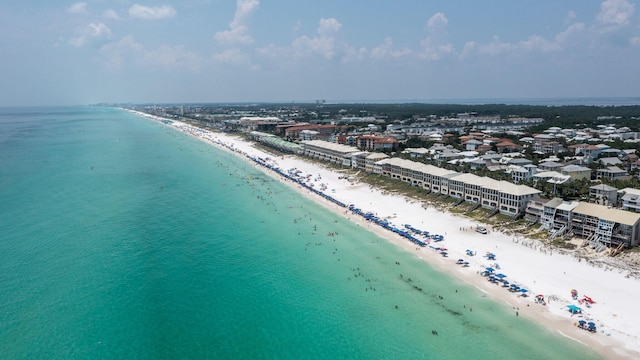 drone / aerial view featuring a beach view and a water view