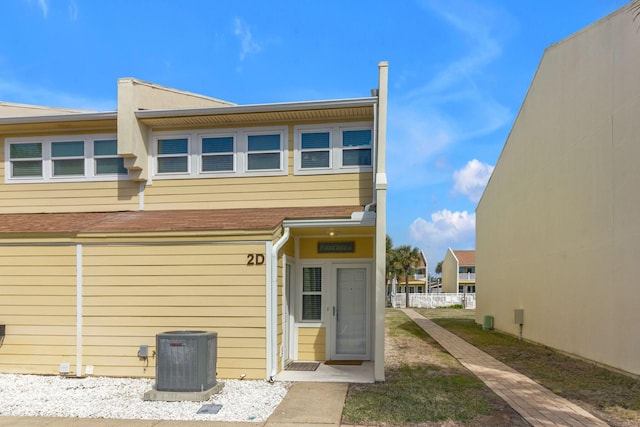 rear view of house featuring central AC