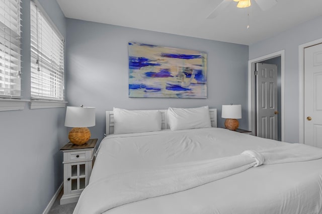 bedroom with ceiling fan and baseboards