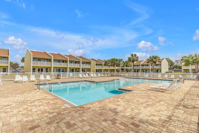 pool featuring a patio area and fence