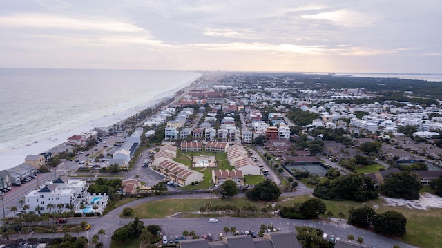 drone / aerial view featuring a beach view and a water view