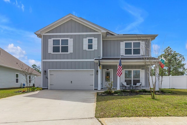 view of front of home featuring covered porch, an attached garage, board and batten siding, a front yard, and fence