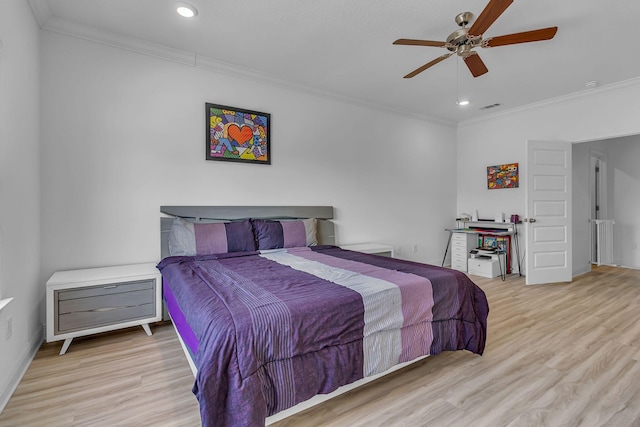 bedroom with ornamental molding, visible vents, and wood finished floors