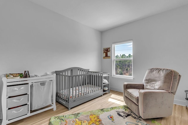 bedroom featuring baseboards and wood finished floors