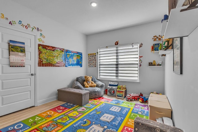 game room featuring wood finished floors and baseboards