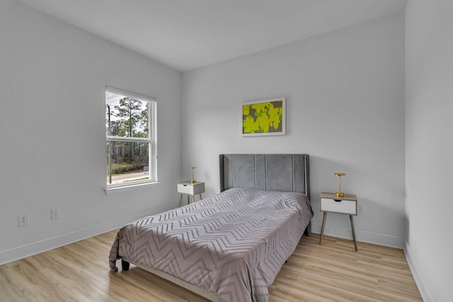 bedroom with wood finished floors and baseboards