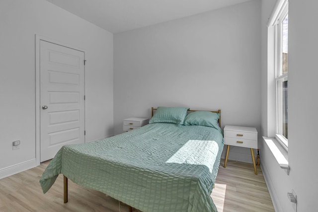 bedroom featuring baseboards and wood finished floors