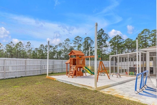 view of playground with a sunroom, a fenced backyard, and a lawn